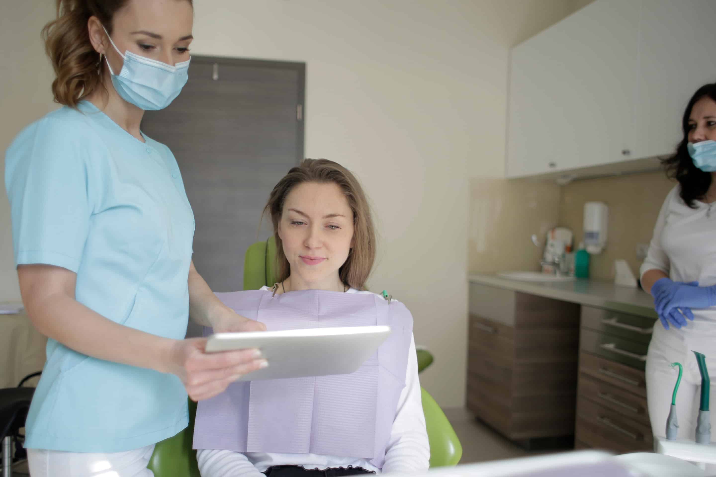 Canva - Woman In A Scrub Suit Beside A Patient (1)